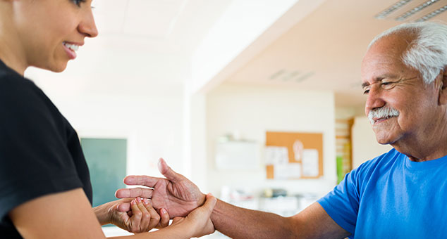 Man at physical therapy for his hand. 