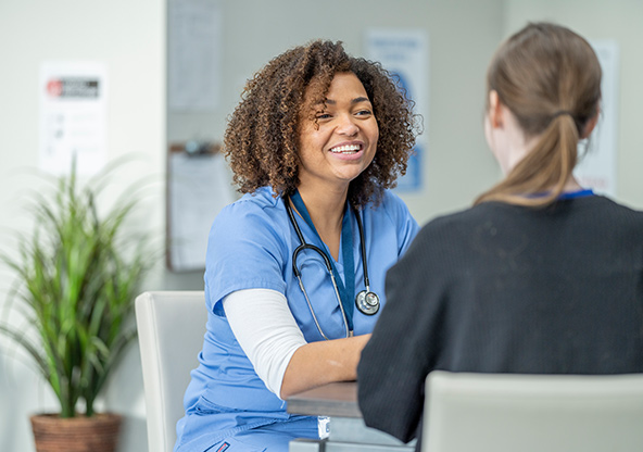 A nurse talks to a patient at a lab location